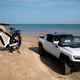 A photo of a Hummer-badged E Bike next to a Hummer electric SUV.